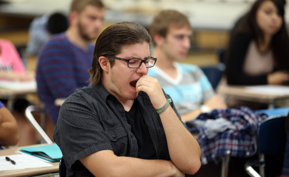 Matt Goodmanson, a junior, yawns during teacher Rich Schram's eighth period honors physics class Aug. 28, 2014 at Buffalo Grove High School in Buffalo Grove, Ill. The American Academy of Pediantrics issued a statement saying school start times should be pushed to 8:30 a.m. or later, as many students aren't getting enough sleep. (Brian Cassella/Chicago Tribune/MCT)