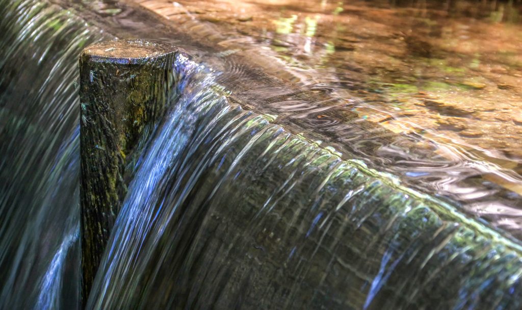 water breaking a dam